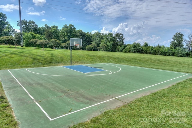 view of sport court with a lawn