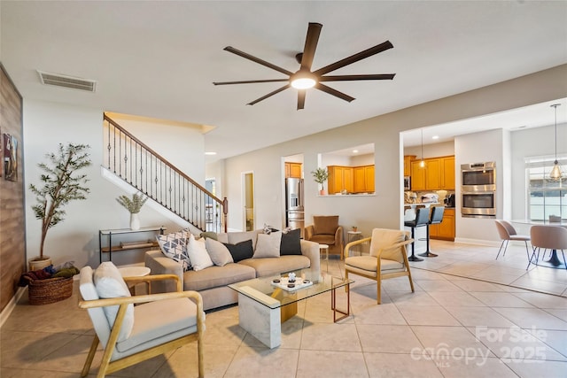 tiled living room featuring ceiling fan