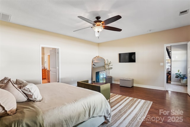 bedroom with ensuite bathroom, ceiling fan, and dark wood-type flooring