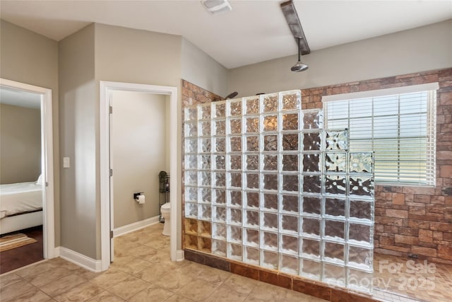 bathroom with toilet and walk in shower