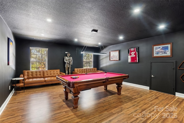 rec room with hardwood / wood-style flooring, a textured ceiling, and billiards