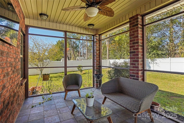 sunroom with wooden ceiling and ceiling fan