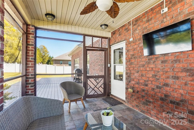 sunroom / solarium with ceiling fan and wood ceiling