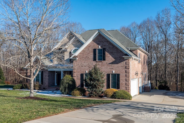 view of property featuring a front yard and a garage