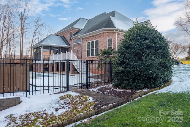 view of front of house with a sunroom