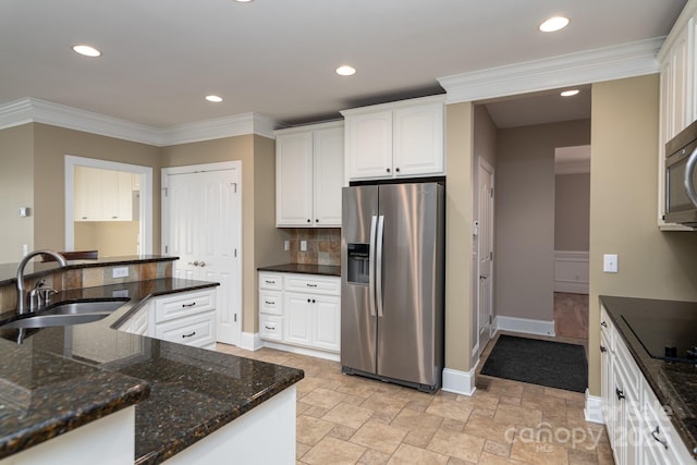 kitchen featuring dark stone counters, black electric cooktop, sink, white cabinets, and stainless steel fridge with ice dispenser