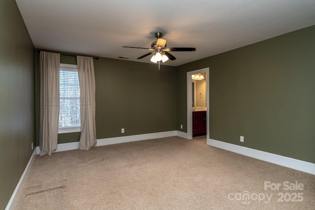 unfurnished room with light colored carpet and ceiling fan