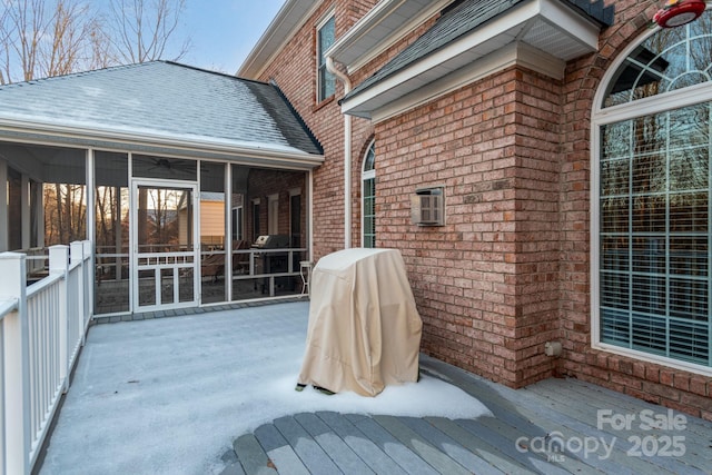 wooden deck with a sunroom