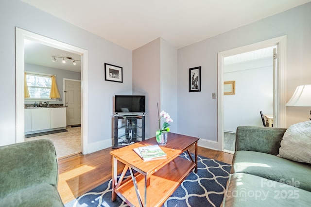 living room featuring hardwood / wood-style flooring and rail lighting