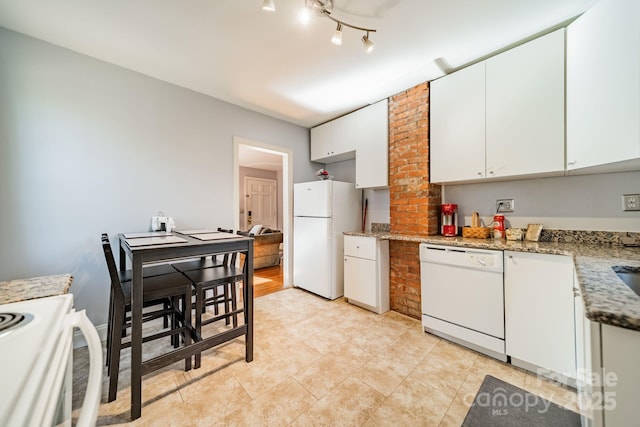 kitchen featuring light stone counters, light tile patterned floors, white appliances, and white cabinets