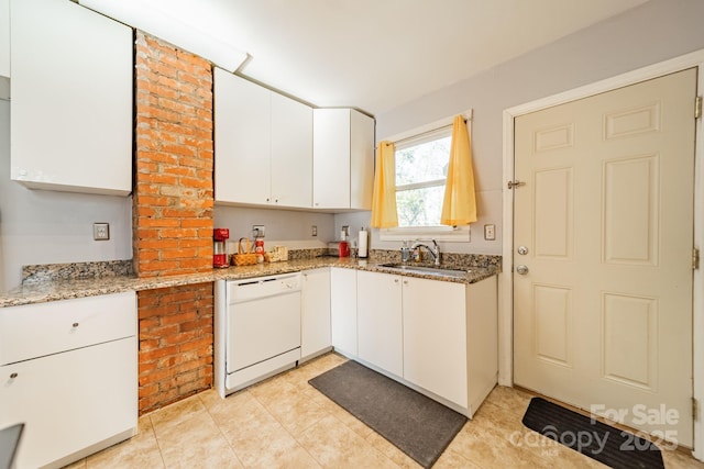 kitchen with sink, light stone countertops, white cabinets, and dishwasher