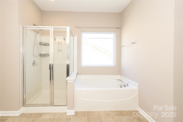 bathroom featuring tile patterned flooring and shower with separate bathtub