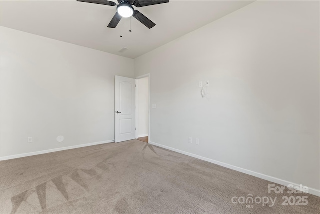 carpeted spare room featuring ceiling fan