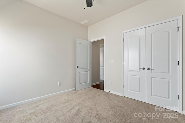 unfurnished bedroom featuring a closet, ceiling fan, and carpet