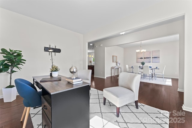 office area with a notable chandelier, baseboards, and wood finished floors