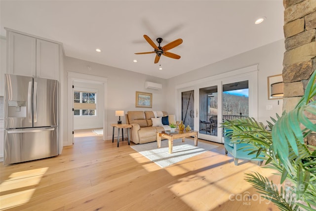 living room with recessed lighting, an AC wall unit, light wood-style flooring, and ceiling fan