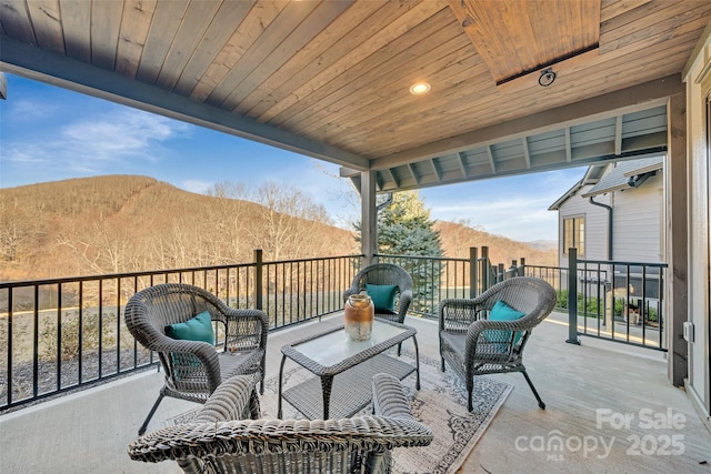 view of patio with an outdoor living space and a mountain view