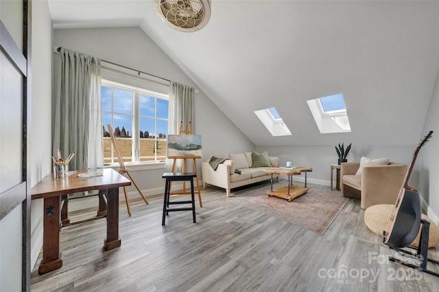 living room featuring vaulted ceiling with skylight, baseboards, and wood finished floors