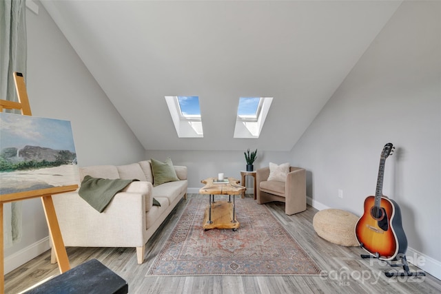 living area with lofted ceiling with skylight, wood finished floors, and baseboards