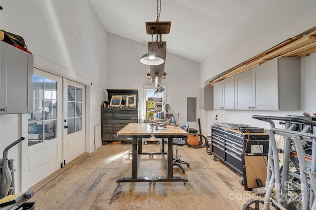 home office with light wood-style flooring, electric panel, french doors, and high vaulted ceiling