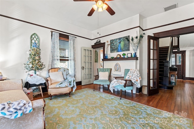 sitting room with ceiling fan and hardwood / wood-style floors