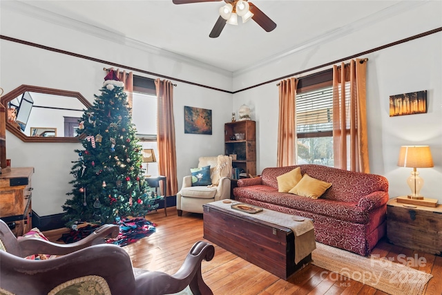 living room with plenty of natural light, ornamental molding, and hardwood / wood-style floors