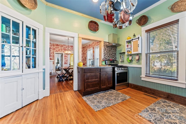 kitchen featuring a notable chandelier, stainless steel gas range, and light hardwood / wood-style flooring