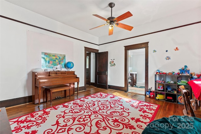 interior space with wood-type flooring and ceiling fan