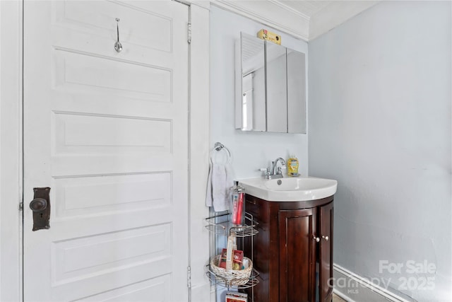 bathroom featuring ornamental molding and vanity