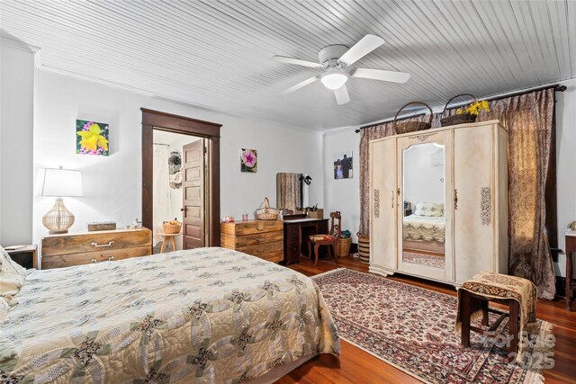 bedroom with ceiling fan and hardwood / wood-style flooring