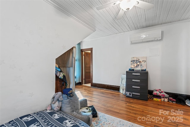 bedroom featuring hardwood / wood-style floors, an AC wall unit, ceiling fan, and ornamental molding