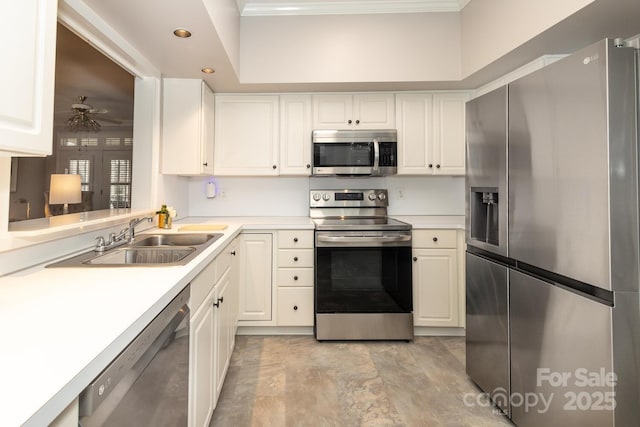 kitchen featuring ceiling fan, sink, white cabinetry, and stainless steel appliances