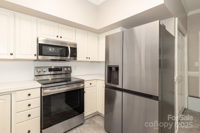 kitchen featuring white cabinetry, crown molding, and stainless steel appliances