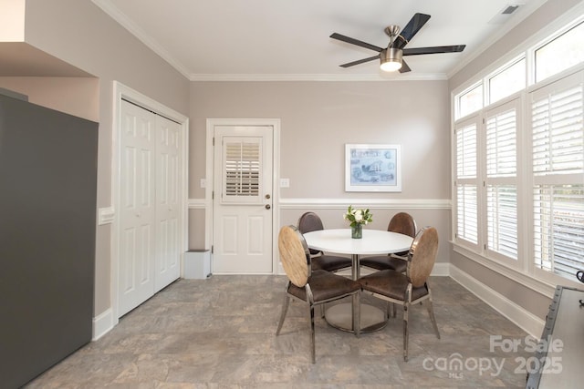 dining room with ceiling fan and crown molding