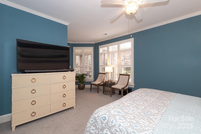 carpeted bedroom with ceiling fan and crown molding