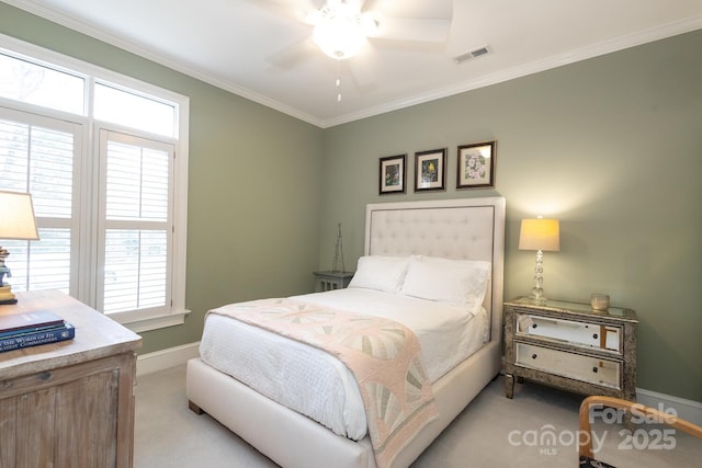 carpeted bedroom with ceiling fan and crown molding