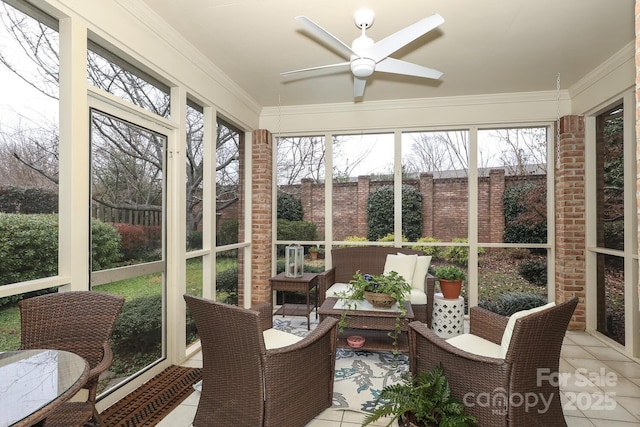 sunroom / solarium featuring ceiling fan