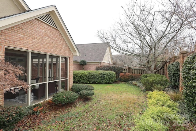 view of yard featuring a sunroom