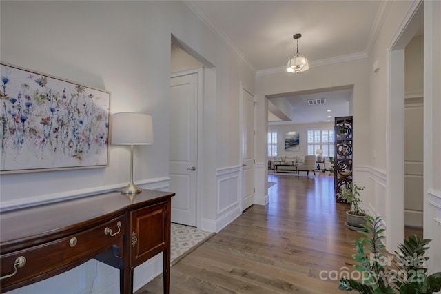 hall featuring ornamental molding and light wood-type flooring