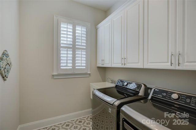 washroom featuring cabinets, washing machine and dryer, and sink