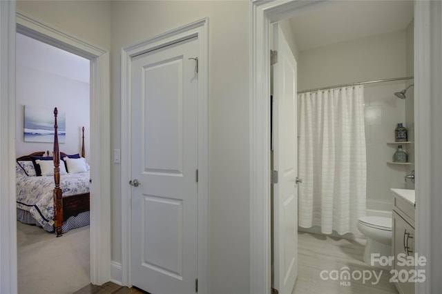 full bathroom featuring vanity, shower / bath combination with curtain, and toilet