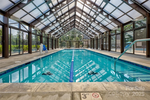 view of pool featuring a patio and glass enclosure