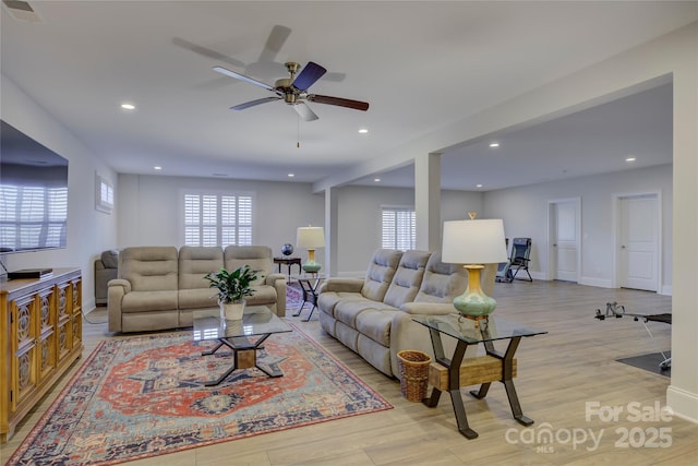 living room with a wealth of natural light and light wood-type flooring