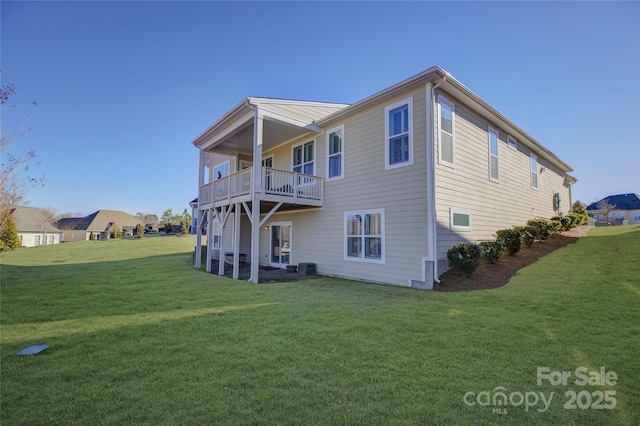 back of house with central AC unit and a yard