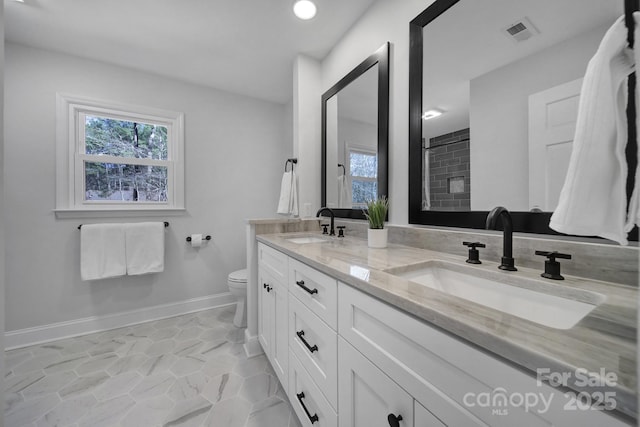 bathroom featuring vanity, tile patterned flooring, and toilet