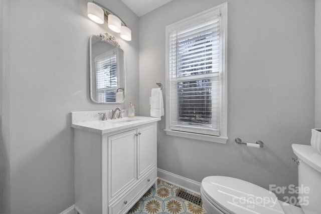 bathroom featuring vanity, tile patterned flooring, and toilet