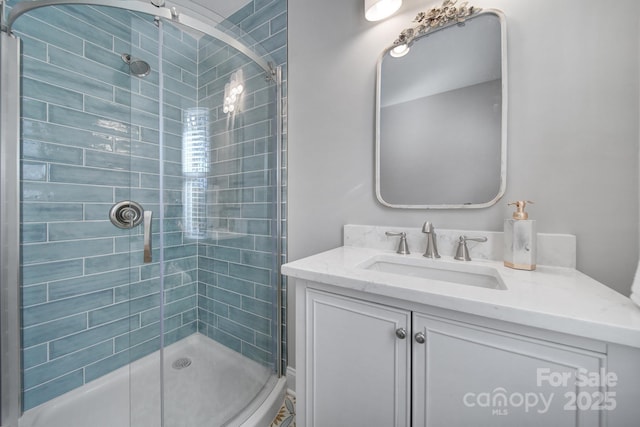 bathroom with vanity and a shower with door