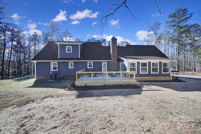 rear view of house featuring a wooden deck and central air condition unit