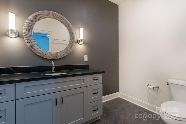 bathroom with tile patterned floors, vanity, and toilet