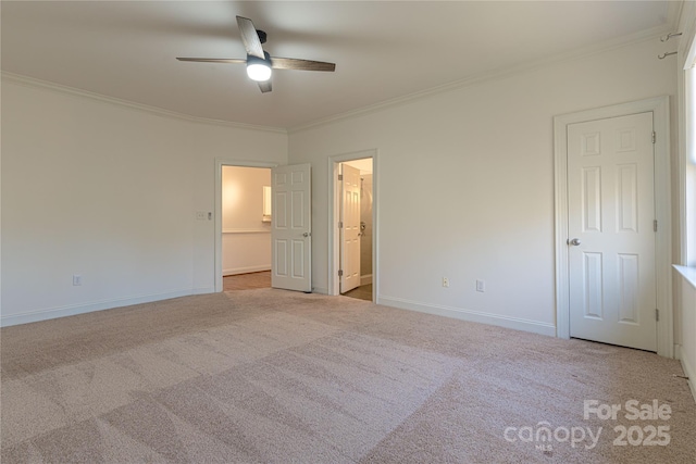 unfurnished bedroom featuring light carpet, connected bathroom, ceiling fan, and crown molding